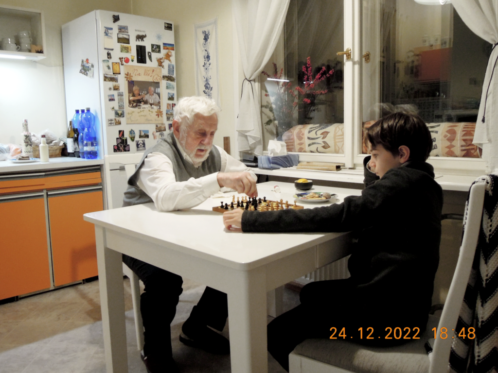 Grandfather and little chess player